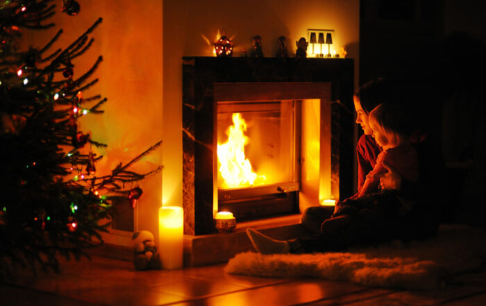 5c091ac5d32fd04ef245dcd9_Mother and daughter sitting near an open fireplace at Christmas | Sweepsmart